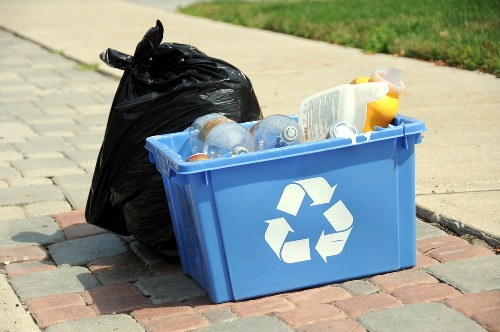 Removal team loading rubbish outside a shop